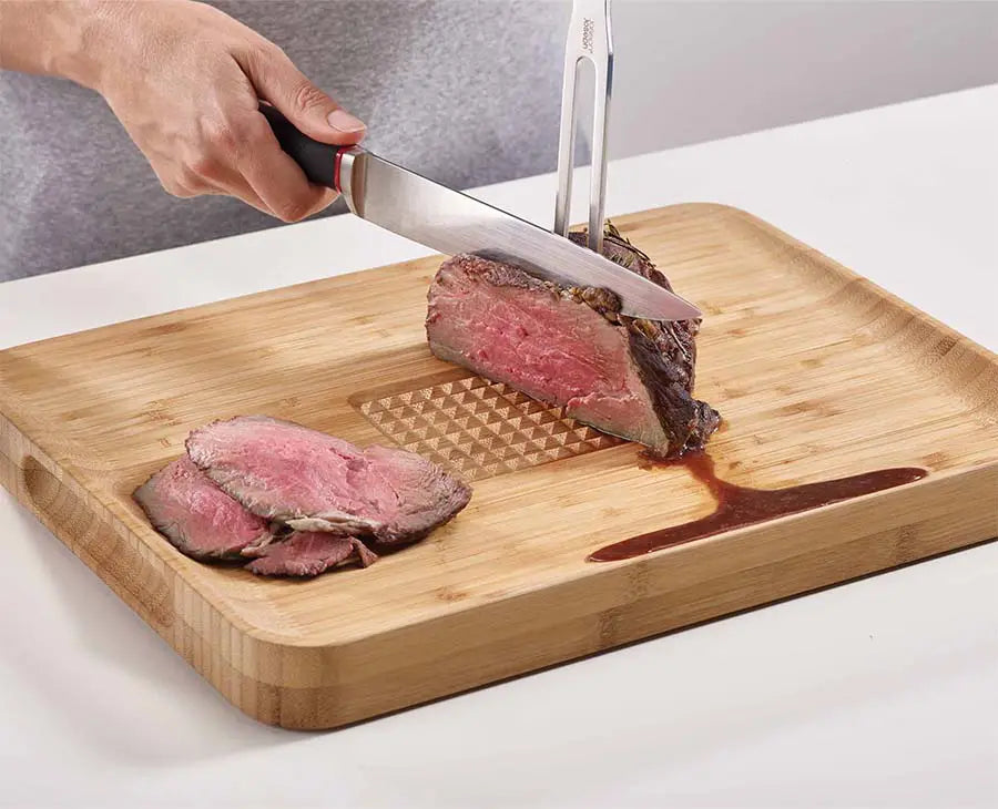 joseph-joseph-cut-carve-bamboo-chopping-board-with-integrated-food-grip image 2