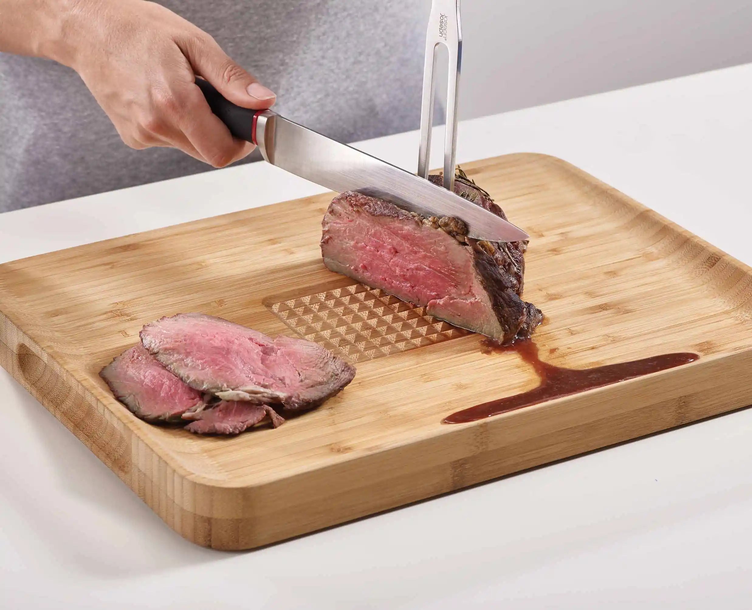 joseph-joseph-cut-carve-bamboo-chopping-board-with-integrated-food-grip image 3